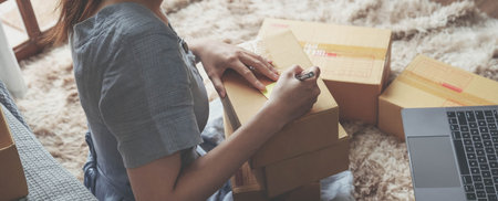 Small Entrepreneurs Start A Home Business By Arranging Goods With Brown Parcel Boxes, Small Home Business Startup Ideas.の写真素材