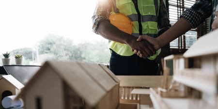 Hand in hand between project contractors and customers due to negotiation of expenses and investments, construction and repair of residential buildings.の写真素材