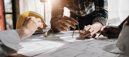 Engineer Teamwork Meeting, Drawing working on blueprint meeting for project working with partner on...