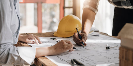 Engineer Teamwork Meeting, Drawing working on blueprint meeting for project working with partner on model building and engineering tools in working site, Construction and structure concept.の写真素材