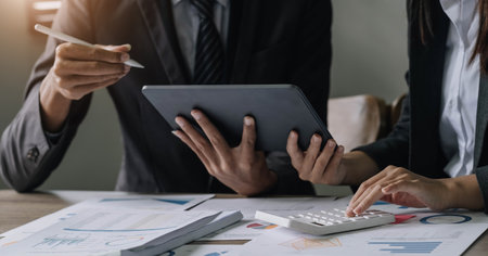 Asian business adviser meeting to analyze and discuss the situation on the financial report in the meeting room.Investment Consultant, Financial advisor and accounting conceptの写真素材