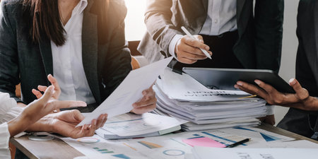 Asian business adviser meeting to analyze and discuss the situation on the financial report in the meeting room.Investment Consultant, Financial advisor and accounting conceptの写真素材