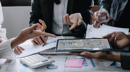 Asian business adviser meeting to analyze and discuss the situation on the financial report in the meeting room.Investment Consultant, Financial advisor and accounting conceptの写真素材