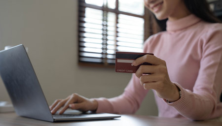 Happy asian Business woman pay online using mobile phone at the office.