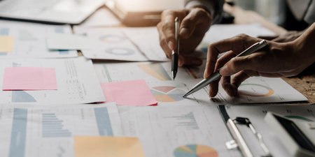 Asian business adviser meeting to analyze and discuss the situation on the financial report in the meeting room.Investment Consultant,Financial Consultant,Financial advisor and accounting conceptの写真素材