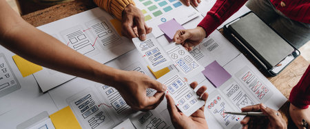 UI UX creative designer team designing wireframe layout for responsive mobile smartphone application in officeの写真素材