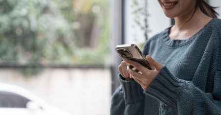 Young Asian beautiful woman using smart phone for business, online shopping, transfer money, financial, internet banking.の写真素材