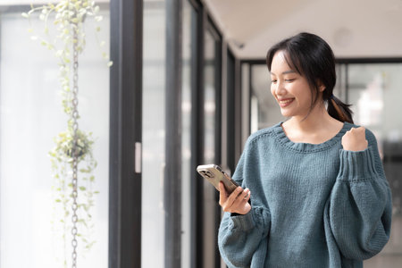 Young Asian beautiful woman using smart phone for business, online shopping, transfer money, financial, internet banking.の写真素材