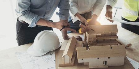 Engineer Teamwork Meeting, Drawing working on blueprint meeting for project working with partner on model building and engineering tools in working site, Construction and structure concept.の写真素材