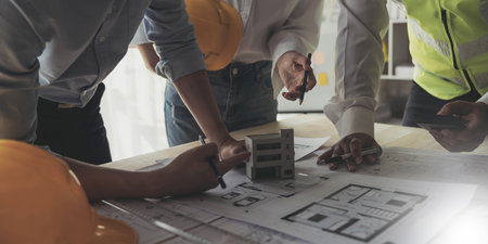 Engineer Teamwork Meeting, Drawing working on blueprint meeting for project working with partner on model building and engineering tools in working site, Construction and structure concept.の写真素材