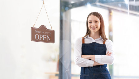 Portrait of a happy waitress standing at restaurant entrance. Portrait of mature business...