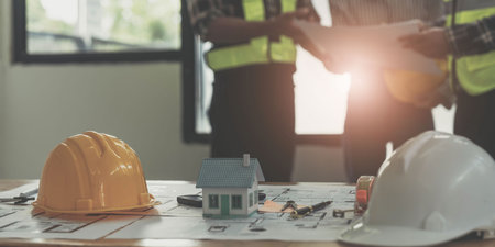 Civil engineer teams meeting working together wear worker helmets hardhat on construction site in modern city. Foreman industry project manager engineer teamwork. Asian industry professional team.の写真素材