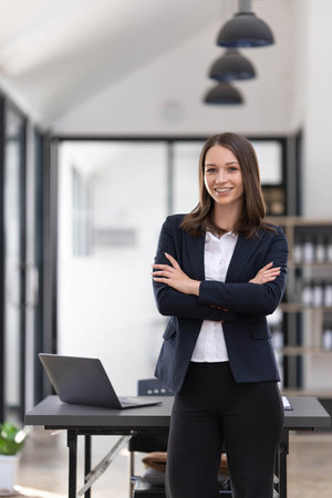 Young asian businesswoman using the tablet to analyze business data while she is standing at the...