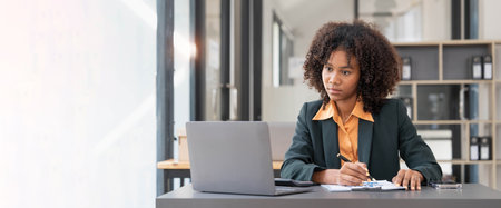 Business woman using calculator for do math finance on wooden desk in office and business working background, tax, accounting, statistics and analytic research concept.の写真素材