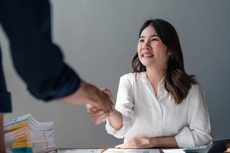 Business handshake for teamwork of business merger and acquisition,successful negotiate,hand shake,two businessman shake hand with partner to celebration partnership and business deal concept..の写真素材