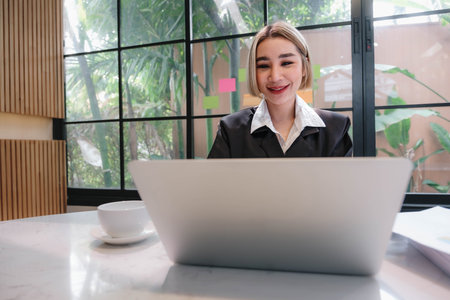 Business woman using calculator for do math finance on wooden desk in office and business working background, tax, accounting, statistics and analytic research concept.の写真素材