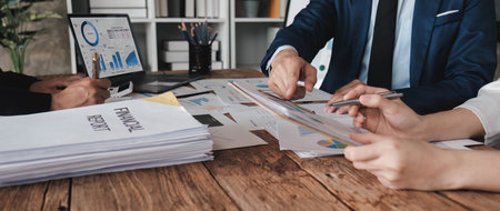 Business People Meeting using laptop computer,calculator,notebook,stock market chart paper for analysis Plans to improve quality next month. Conference Discussion Corporate Concept..の写真素材