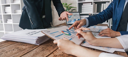 Business People Meeting using laptop computer,calculator,notebook,stock market chart paper for analysis Plans to improve quality next month. Conference Discussion Corporate Concept..の写真素材