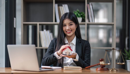 Real estate concept, businessman holding a house icon. House on Hand.Property insurance and security concept. Protecting gesture of female and symbol of house..の写真素材