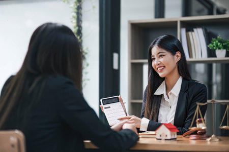 House model with agent and customer discussing for contract to buy, get insurance or loan real estate or property...の写真素材