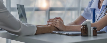 female doctor hold hand of caucasian woman patient give comfort, express health care sympathy, medical help trust support encourage reassure infertile patient at medical visit, closeup view.の写真素材