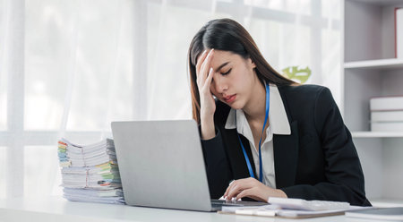 asian woman thinking hard concerned about online problem solution looking at laptop screen, worried...