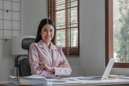 Business woman using calculator for do math finance on wooden desk in office and business working background, tax, accounting, statistics and analytic research concept..の写真素材