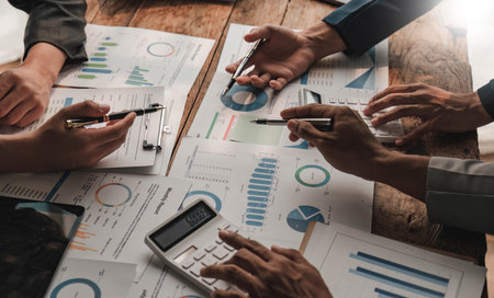 Business People Meeting using laptop computer,calculator,notebook,stock market chart paper for analysis Plans to improve quality next month. Conference Discussion Corporate Concept..の写真素材