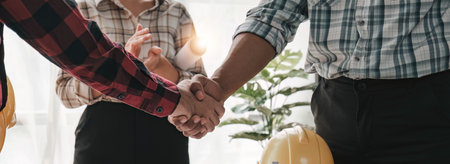Hand in hand between project contractors and customers due to negotiation of expenses and investments, construction and repair of residential buildings..の写真素材