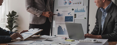 Business People Meeting using laptop computer,calculator,notebook,stock market chart paper for analysis Plans to improve quality next month. Conference Discussion Corporate Concept..の写真素材