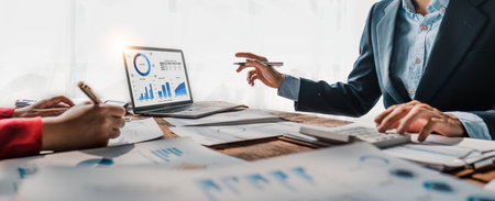 Business People Meeting using laptop computer,calculator,notebook,stock market chart paper for analysis Plans to improve quality next month. Conference Discussion Corporate Concept.の写真素材