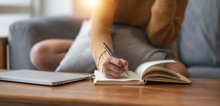 Close up of female hands who write in a notebook. Work at home