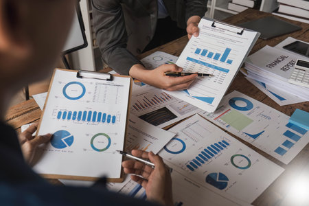 Business People Meeting using laptop computer,calculator,notebook,stock market chart paper for analysis Plans to improve quality next month. Conference Discussion Corporate Concept..の写真素材