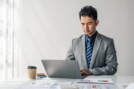 Businessman using calculator for do math finance on wooden desk in office and business working background, tax, accounting, statistics and analytic research concept..の写真素材