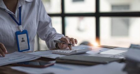 Business woman using calculator for do math finance on wooden desk in office and business working...