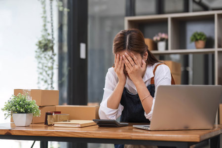 Small Business, Startup SME, Owner Entrepreneurs. Asian woman with unsuccess business online shopping crying and serious face unhappy mood.の写真素材