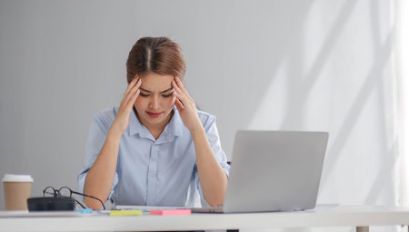 Puzzled confused asian woman thinking hard concerned about online problem solution looking at laptop...