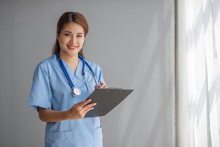 Portrait of female asian doctor standing in her office at clinic.の写真素材