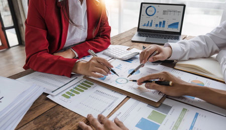 Business People Meeting using laptop computer,calculator,notebook,stock market chart paper for analysis Plans to improve quality next month. Conference Discussion Corporate Concept..の写真素材
