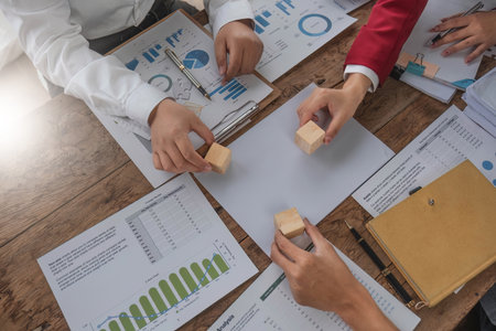 A group of business people assembling jigsaw puzzle. The concept of cooperation, teamwork, help and...