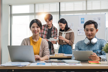 A group of professional Asian UI, UX graphic designers, or developers is in the meeting, brainstorming and planning a new project together.の写真素材