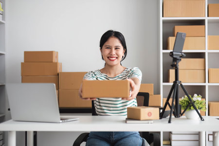 Starting Small business entrepreneur SME freelance, Portrait young woman working at home office, BOX, smartphone, laptop, online, marketing, packaging, delivery, b2b, SME, e-commerce concept..の写真素材