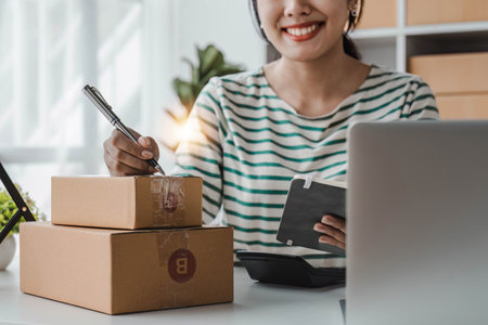 Starting Small business entrepreneur SME freelance, Portrait young woman working at home office, BOX, smartphone, laptop, online, marketing, packaging, delivery, b2b, SME, e-commerce concept..の写真素材