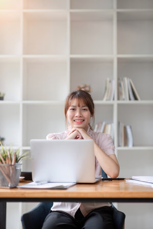Portrait of accountant woman working on financial strategy as growth at startup company with smile.の写真素材