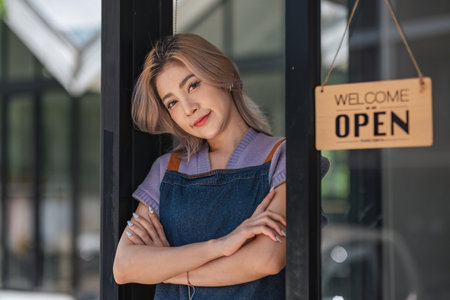 Opening a small business, A Happy Asian woman in an apron standing near a bar counter coffee shop,...