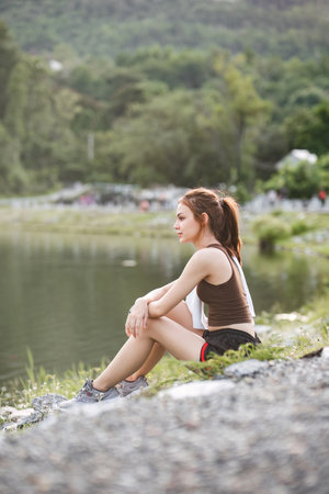 portrait of beautiful asian woman Wipe off your sweat after an evening jog in the park.の写真素材