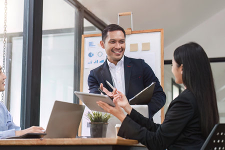 Close up of businesswoman presenting data analysis on board to her boss in companyの写真素材