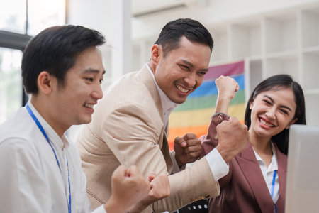 Asain business team Happy to be successful partnership teamwork achieved the desired goalの写真素材