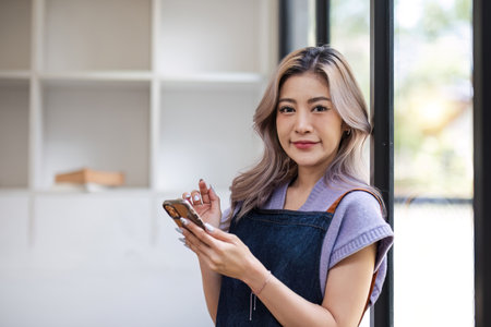 Startup small business entrepreneur SME asian woman receive order on phone. Success young Asian...