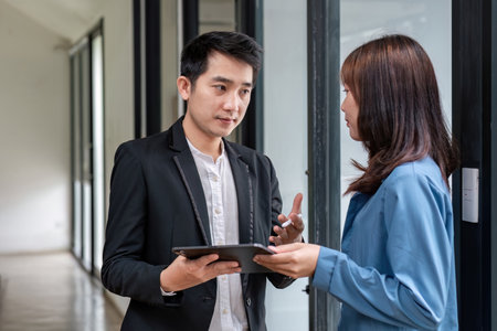 Businessman exchanging ideas for working with technology with young businesswomen.の写真素材